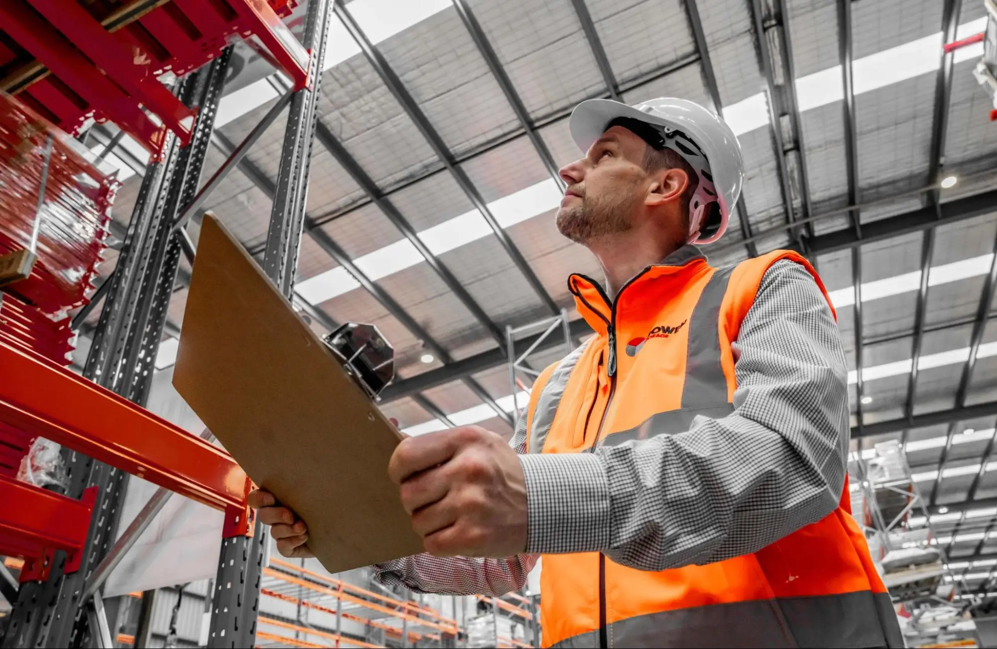 Warehouse manager inspecting pallet racking as part of warehouse layout assessment